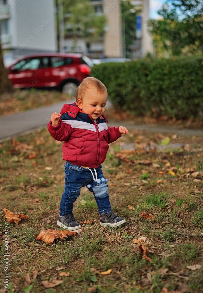 Little boy taking his first steps in the park Little boy taking his first steps in the park