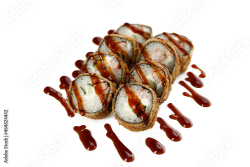 Closeup image of deep fried tempura rolls served with teriyaki sauce isolated at white background.