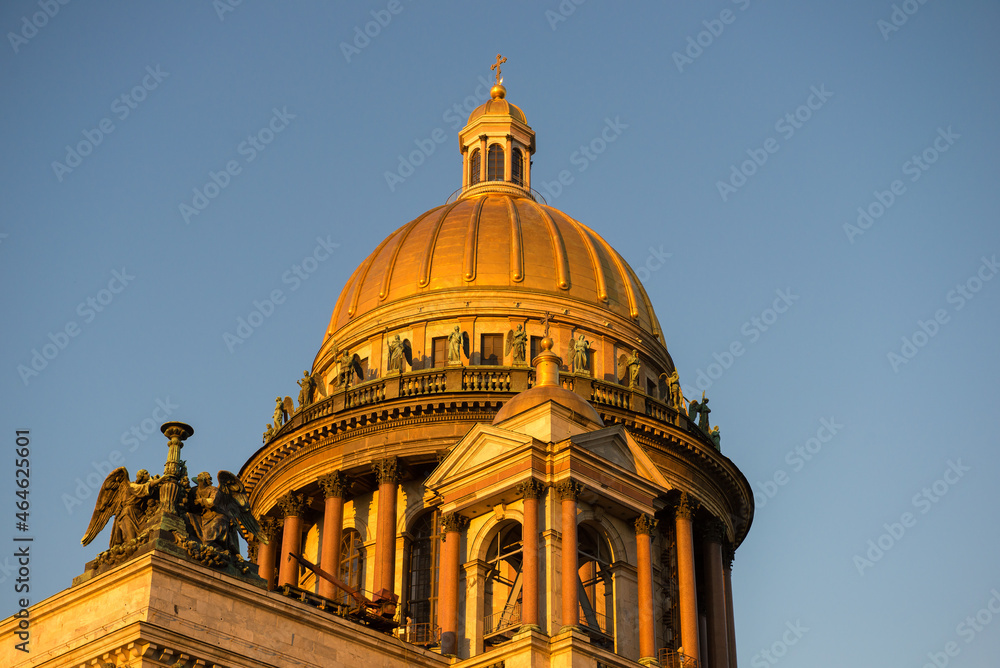 The dome of the ancient St. Isaac's Cathedral is close-up in the evening sunlight. St. Petersburg, Russia