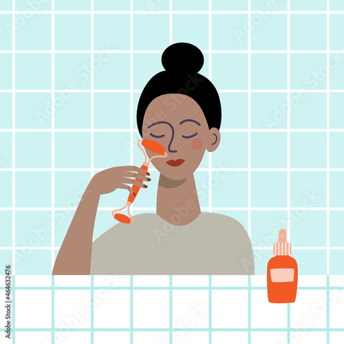 Woman giving herself face massage with gua sha roller.