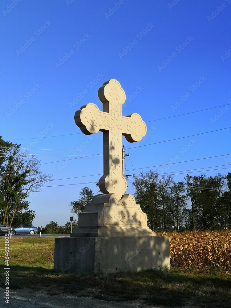 christian or Catholic stone cross on the highway
