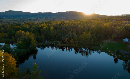 Beautiful Sunset over calm colorful Lake. Sunset landscape on the lake with the falling hot sun. Aerial view of lake.