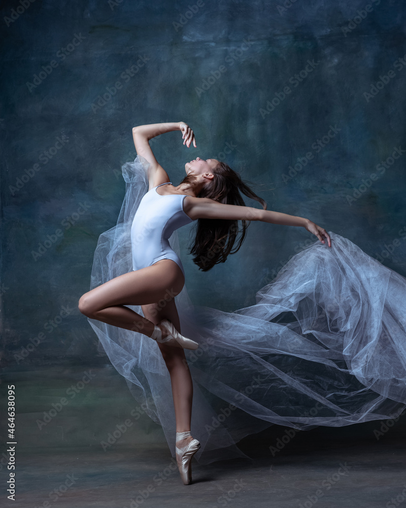 One young and flexible ballet dancer, ballerina dancing isolated on dark vintage studio background. Art, motion, action concept. One young and flexible ballet dancer, ballerina dancing isolated on dark vintage studio background. Art, motion, action concept.