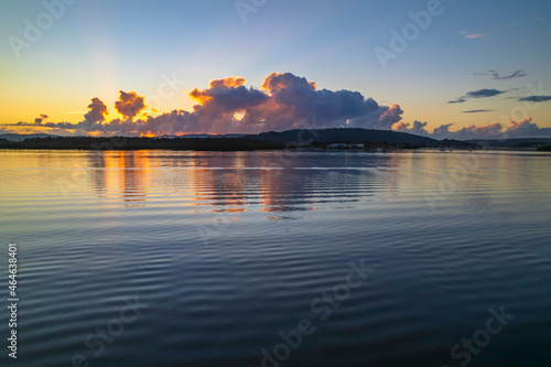 Aerial sunrise over the bay with clouds and reflections