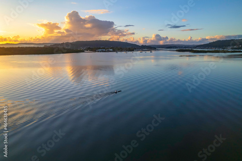 Aerial sunrise over the bay with clouds and reflections