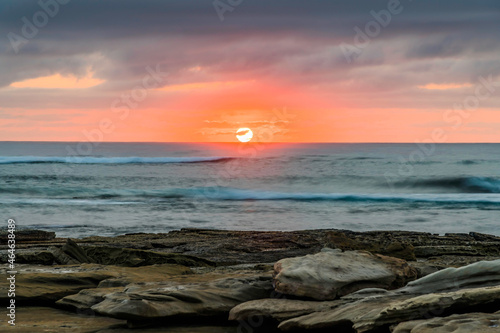 Sunrise seascape with rocky foreground