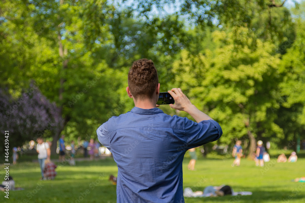a man takes pictures of people in the park a man takes pictures of people in the park