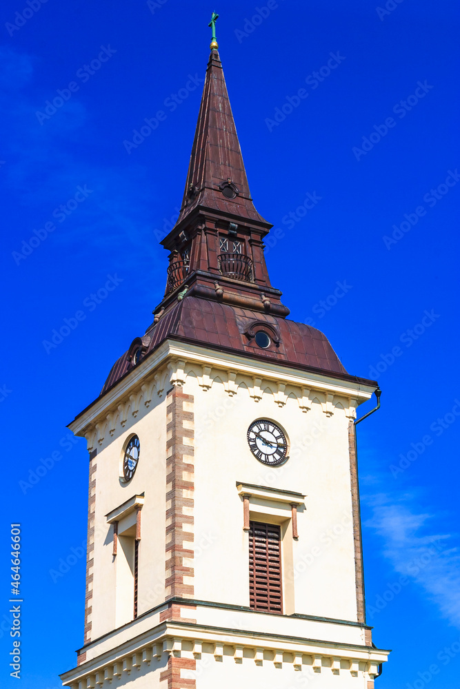 Church tower with clock against a blue sky