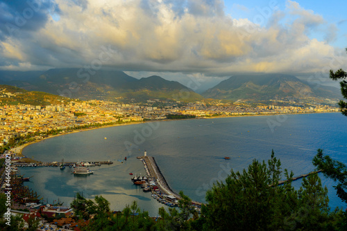 Fototapeta Naklejka Na Ścianę i Meble -  view of Alanya and the port illuminated by the setting sun with colorful clouds in autumn
