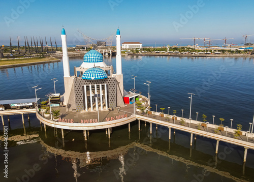Aerial view of Amirul Mukminin Mosque, a Floating Mosque in Makassar, located in famous tourist destination, Losari Beach, South Sulawesi, Indonesia. New landmark of Makassar City.  photo
