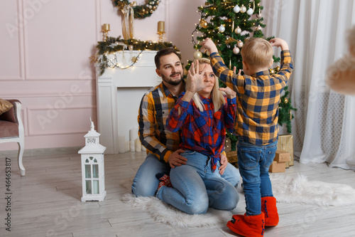 Happy family near christmas tree having fun on the floor. © BY-_-BY