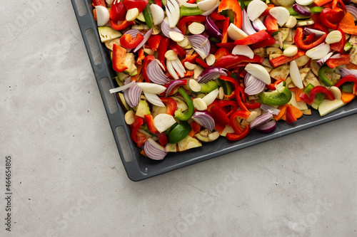 Fresh assorted autumn cut vegetables on a baking sheet ready to roast in the oven