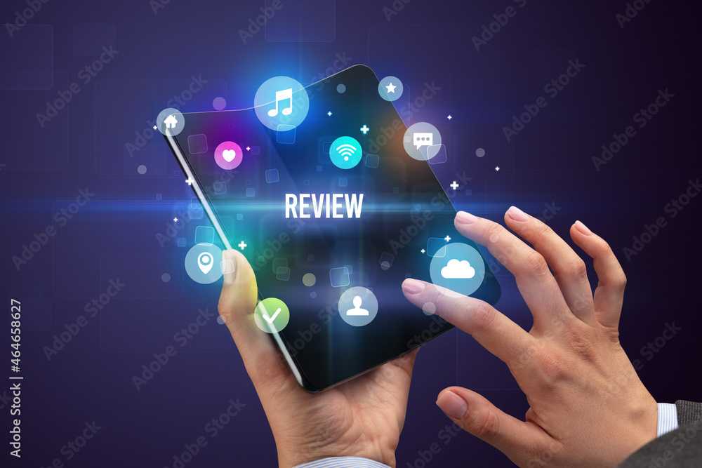 Businessman holding a foldable smartphone Businessman holding a foldable smartphone