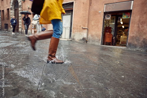 running and jumping on puddles on a rainy day.Rainy day outdoors.