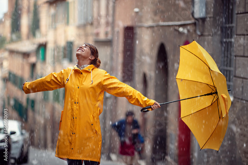 Happy caucasian woman enjoying rainy day