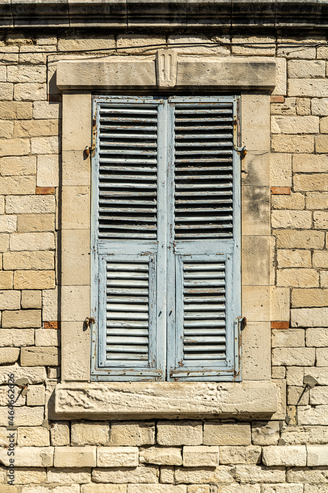 Shuttered window in stone wall
