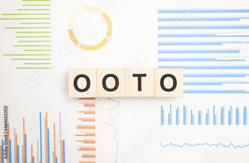 Word ooto on wooden cubes over bright background with copy space