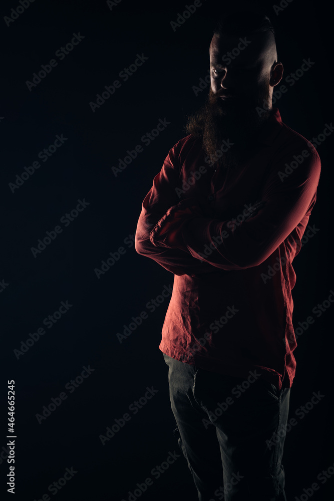 Silhouette of a beautiful strong nordic man with stylish hairstyle and beard on a isolated background.
