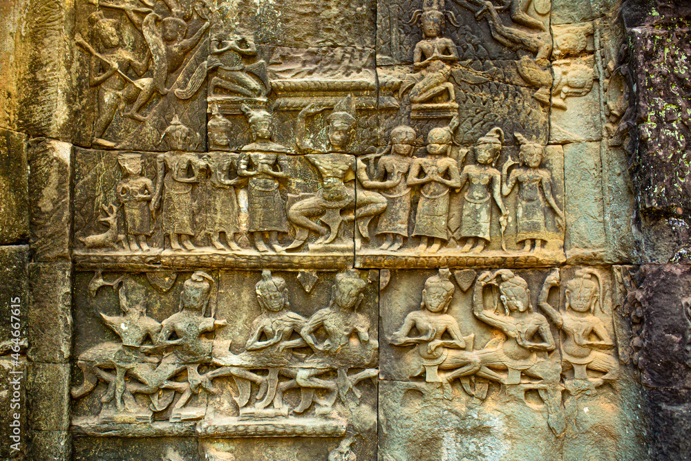 Stone bas-reliefs on the ruins of the ancient city of Angkor Wat in Cambodia. Towers of the temple of the Kmer people streets and ruins of houses. Traveling to the sights of ancient civilizations.