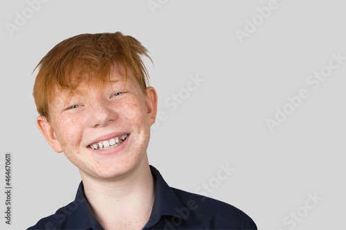 Portrait of a teenage redhead boy with tousled hair.