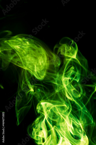 Green smoke on black background. © peterkai
