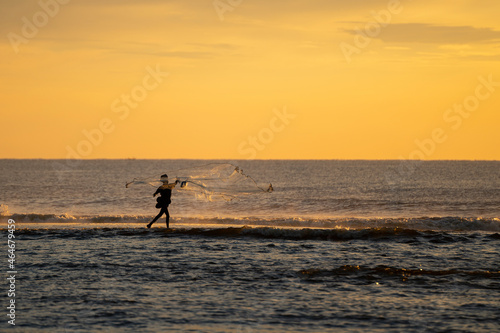 fisherman throwing his net © aadhithan