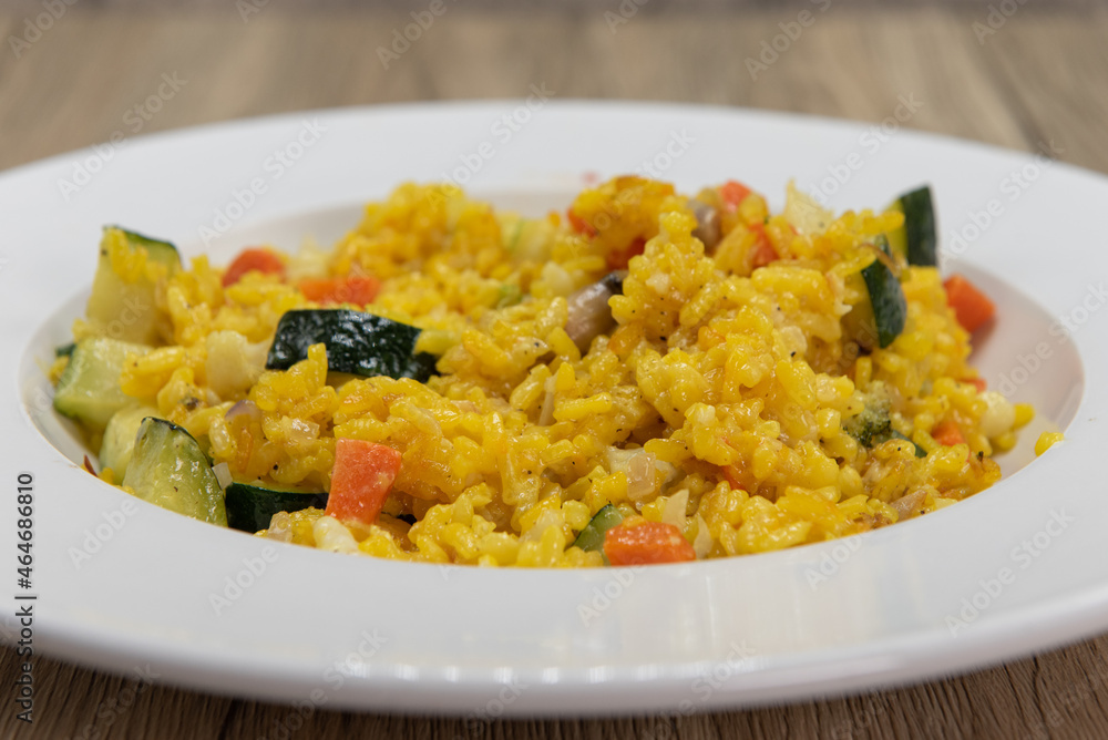 Flavored Italian rice steamed with chopped vegetables has very bright colors in a white bowl Flavored Italian rice steamed with chopped vegetables has very bright colors in a white bowl