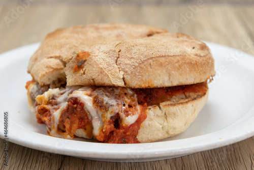Veal parmesan sandwich dripping cheee and sauce out from within the bread for this delicious Italian meal