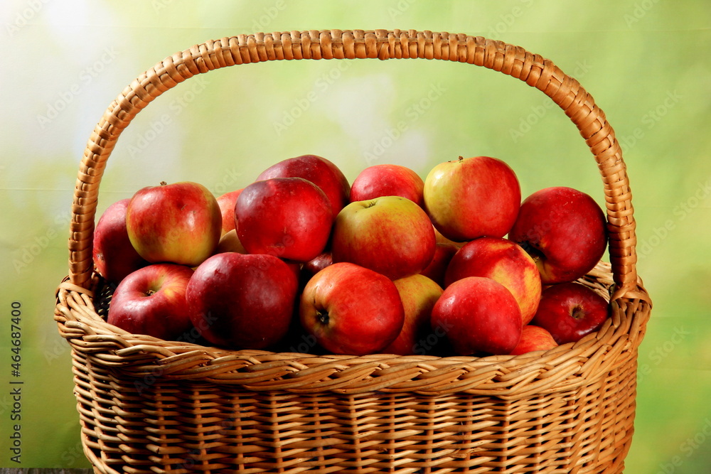 Red apples in wicker basket on the table. Fresh ripe apples in basket Red apples in wicker basket on the table. Fresh ripe apples in basket