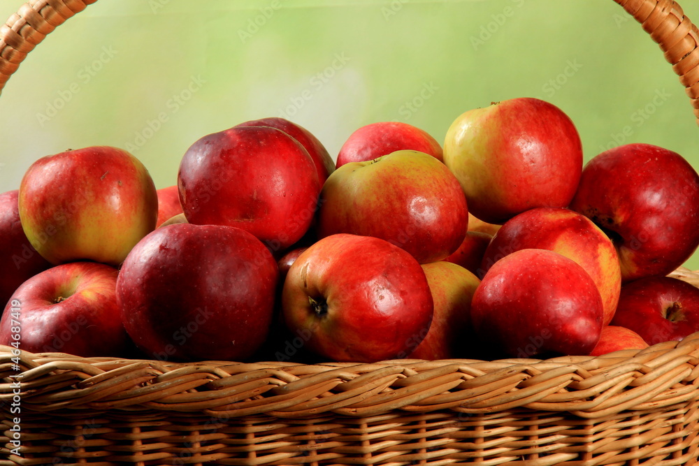Red apples in wicker basket on the table. Fresh ripe apples in basket Red apples in wicker basket on the table. Fresh ripe apples in basket