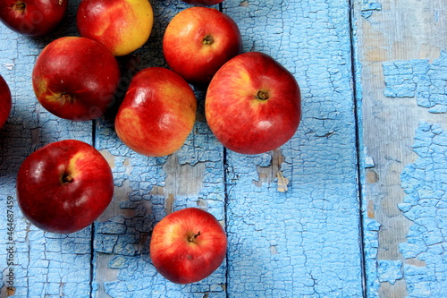 Ripe red apples on a rustic wooden board background. Red juicy apples