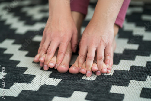 Woman's leg hurts, pain in the foot, massage of female feet at home