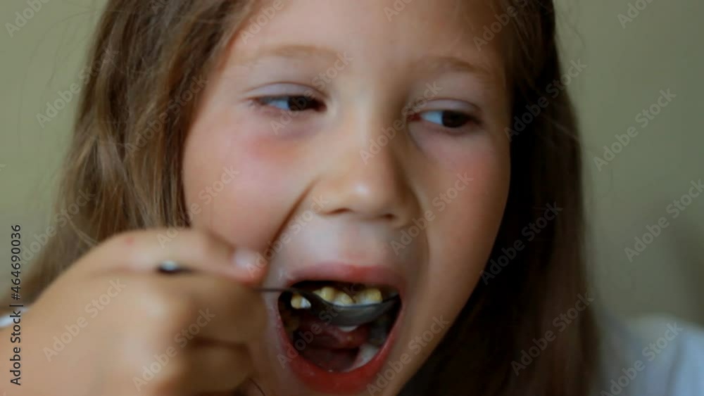 Closeup portrait baby girl eating food with with help spoon. Closeup portrait baby girl eating food with with help spoon.