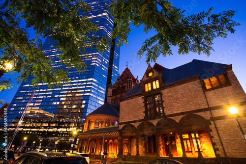 Historic Trinity Church in Boston Massachusetts seen in the evening with the John Hancock Tower visible in the background photo