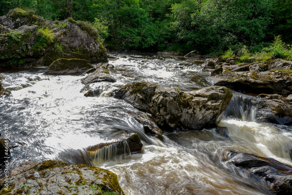 Water flowing over rocks in a river in Scotland Water flowing over rocks in a river in Scotland