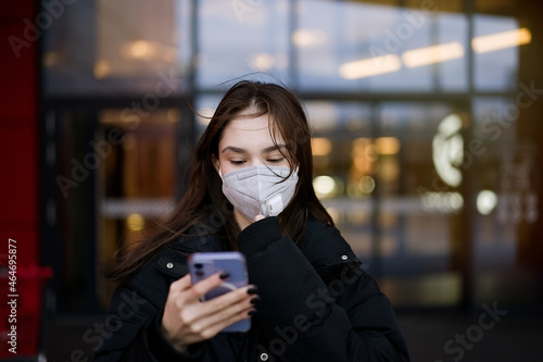 Portrait teenage girl wearing a face mask on background of a shopping mall