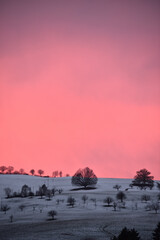 Fotobehang Koraal Avondrood boven Wintersingen landschap  © Matthias Rickli