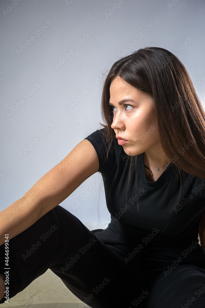 Model with long hair posing in black suit on white background in studio. Fashion concept Model with long hair posing in black suit on white background in studio. Fashion concept