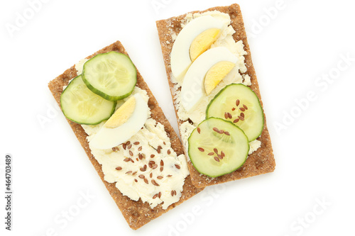 Crispbread with cream cheese, eggs and cucumbers isolated on white background
