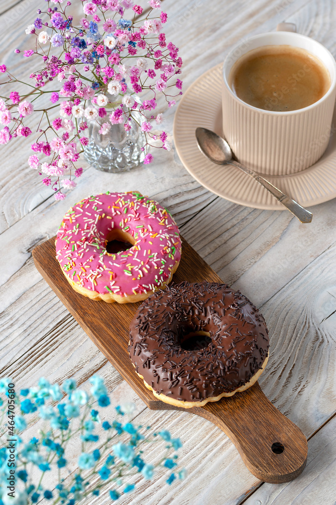 Donuts and a cup of coffee for breakfast. Selective focus.