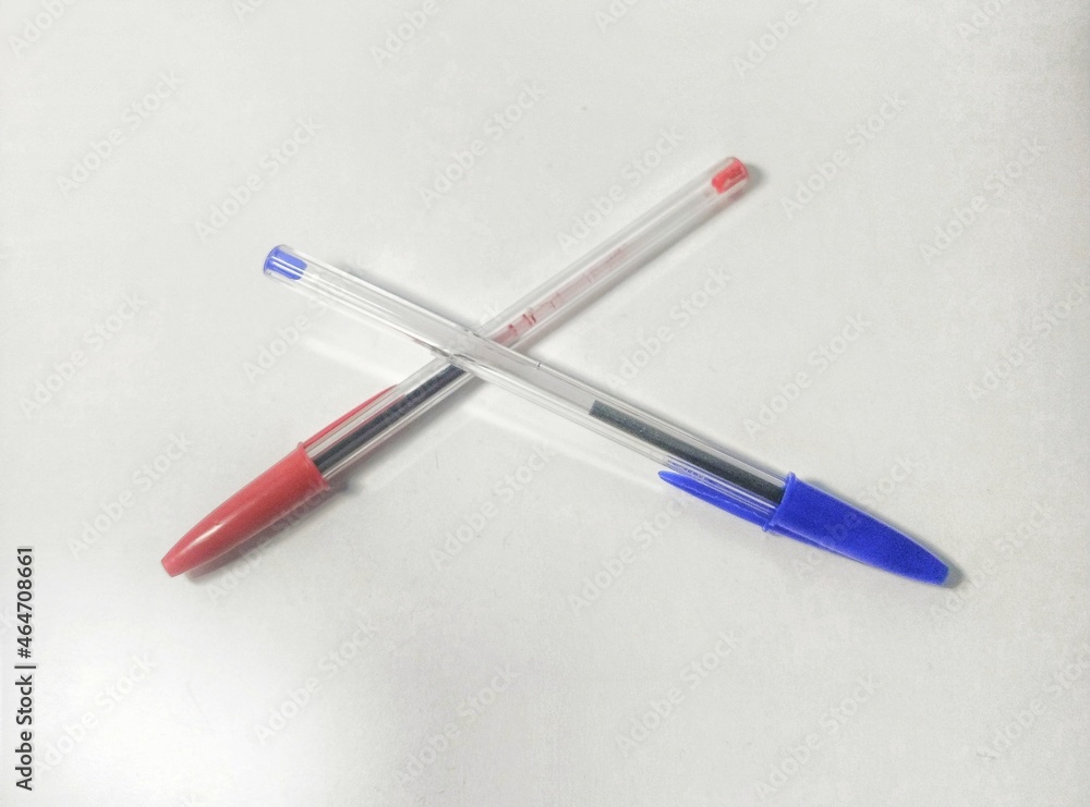 Blue and red pens on white