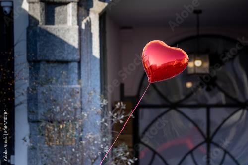 red heart-shaped balloon flying pushed by the wind