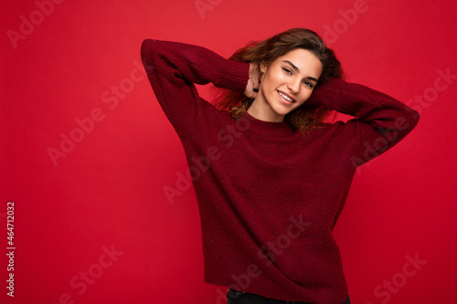 Photo of beautiful positive smiling adult woman wearing stylish clothes standing isolated on colorful background with copy space looking at camera © Ivan Traimak