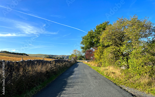 Country lane in autumn, deep in the Yorkshire Dales, late evening near Arncliffe, Skipton, UK photo