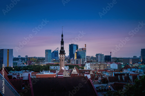 Tallinn Skyline at sunset with Town Hall Tower and the Modern Buildings of City Centre on background - Tallinn, Estonia