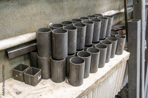 Round pipes are cut into short pieces and stacked neatly in a locksmith's shop.