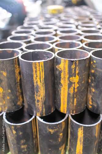 Round pipes are cut into short pieces and stacked neatly in a locksmith's shop.