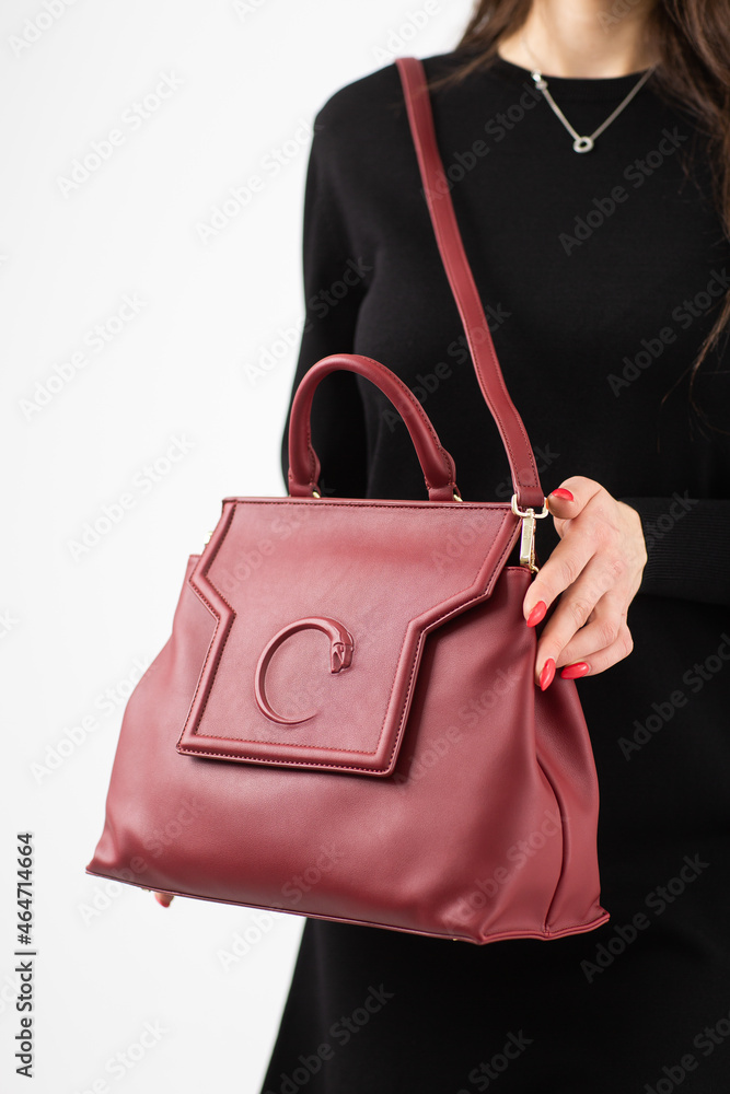 Women's red leather bag front view. The trendy purse for office, business trips or casual occasions isolated against the white background.