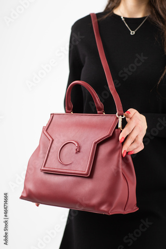 Obraz na płótnie Women's red leather bag front view. The trendy purse for office, business trips or casual occasions isolated against the white background. w salonie