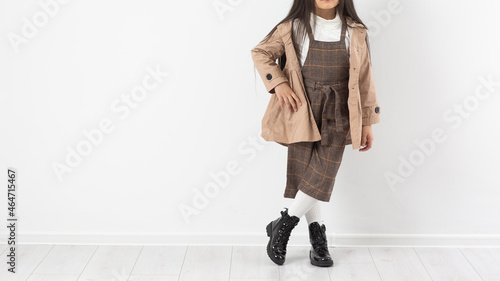 Obraz na płótnie Attractive girl in checkered overalls on a white background. Catalog, clothing magazine. w salonie